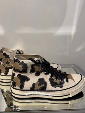 Converse high top sneakers in beige, black and tan cow print